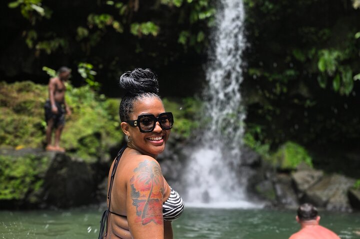 Guest enjoying a waterfall pool in Dominica with Greygoose Tours